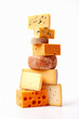 A picturesque display of assorted cheese slices stacked in a pyramid formation, showcasing a variety of textures, colors, and flavors. From creamy brie to tangy cheddar, culinary diversity. 