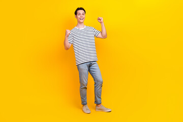 Poster - Full size photo of overjoyed student dressed striped t-shirt jeans trousers win betting scream yeah isolated on yellow color background