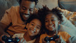 Father and daughter smiling and playing video game console while sitting at home and having a good time