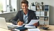 © Shamim Akhtar - Portrait of a young businessman working with documents and an invoice while seated at a desk in the office and grinning at the camera