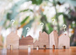Miniature house with question mark icons.The concept of choosing suitable house for planning living in the future. Real estate