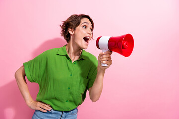 Sticker - Photo portrait of attractive young woman hold shout megaphone empty space dressed stylish green clothes isolated on pink color background