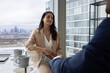 © ReeldealHD images - Businesswoman listening in a corporate meeting with view of London city skyline