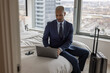 © ReeldealHD images - Business executive in hotel working using his laptop computer