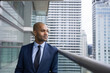 © ReeldealHD images - African American businessman on office balcony looking confidently at city skyline