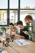 © LIGHTFIELD STUDIOS - three team members engaged in project discussion in startup workspace, men in 20s looking at laptop