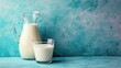 glass of milk, a jug of milk on blue background. The concept of farm dairy products, milk day. Copy space.