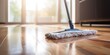 Mop and clean the floor with a mop and cleaning tools on the parquet floor.