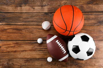 Poster - Many different sports balls on wooden background, flat lay. Space for text