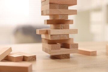 Sticker - Jenga tower made of wooden blocks on table indoors, closeup