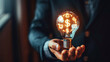 Businessman Holding Glowing Light Bulb with Financial Symbols Inside