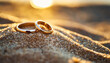 Wedding rings gleam on sandy beach under radiant backlight, symbolizing eternal love and commitment
