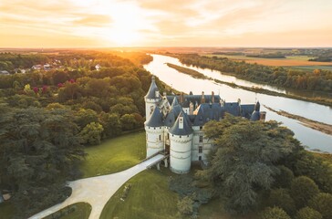 Wall Mural - The imposing Chaumont-sur-Loire Castle stands proudly, overlooking the meandering river below. The ancient walls, towers, and lush greenery create a breathtaking scene from above