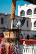 Doha, Qatar - February 8, 2024: dove on top of bucket filled with water in well at Doha Souq Waqif