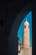 Doha, Qatar - February 8, 2024: The minaret of Al Ahmed Mosque through an arch inside Souq Waqif, Doha, Qatar