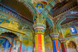 Thanjavur, Tamil Nadu, India - The high arches artworks and colorfully painted wall murals and ceilings of the ancient 17th-century durbar hall Maratha Palace in the town of Thanjavur.