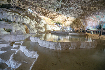 Wall Mural - The scenic views of Kaklık cave which is full of dripstones, stalactites and stalagmites. There are also travertine formations and a small thermal lake at the bottom of the cave in Denizli, Turkey