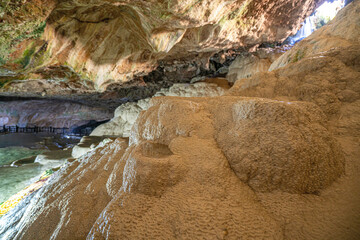 Wall Mural - The scenic views of Kaklık cave which is full of dripstones, stalactites and stalagmites. There are also travertine formations and a small thermal lake at the bottom of the cave in Denizli, Turkey