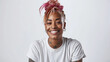 young woman with a cheerful smile, sporting a trendy top bun with pink hair, a nose ring, and visible tattoos, embodying a modern and joyful aesthetic.