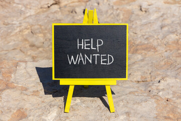Wall Mural - Help wanted and support symbol. Concept words Help wanted on black chalk blackboard on a beautiful stone background. Business, support, help wanted concept. Copy space.
