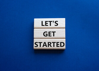 Wall Mural - lets get started symbol. concept words lets get started on wooden blocks. beautiful deep blue backgr