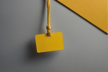 Wall Mural - empty Blank nametag on a string on yellow background copy space