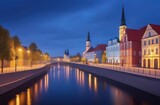 Fototapeta Londyn - a small cozy city, a night city on the riverbank, a city embankment with lanterns, a European city, colorful buildings and towers