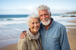 close up and portrait of two happy and active seniors or pensioners having fun and enjoying looking at the sunset smiling with the sea - old people outdoors enjoying vacations together