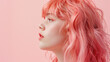 Profile of girl with pink hair on pastel background.