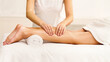 © Prostock-studio - Massage therapist massaging woman calves in spa center
