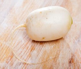 Wall Mural - Many white radish on wooden surface