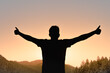© kieferpix - Joyful Young Happy Positive Man Arms Up Looking Out to the Sunrise Feeling At Peace In Nature