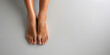 Female feet with pedicure on grey background. Top view. Flat lay. Banner design.