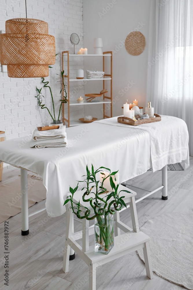Interior of spa salon with couch and burning candles