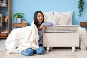 Sticker - Young Asian woman with radiator in bedroom