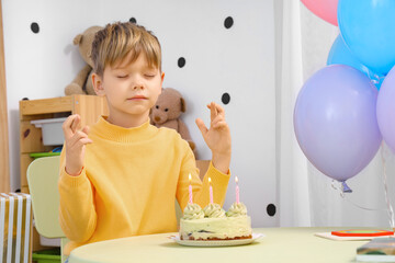 Poster - Cute little boy with Birthday cake making wish at home