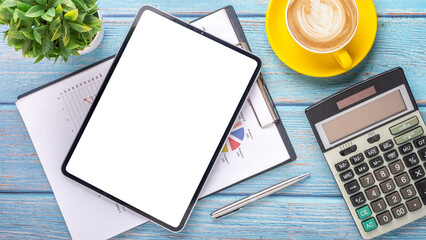 Wall Mural - Financial charts on clipboard with a digital tablet, calculator, and a cup of coffee on a rustic blue wooden table.