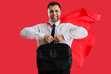 Poster - Businessman with superhero cape and briefcase on red background