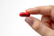 © Ari - Hand holding red pill, healthcare: medicine, antibiotic, supplement
