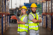 © eakgrungenerd - Male and Female professional worker wearing safety uniform using tablet inspect goods on shelves in warehouse. supervisor worker checklist stock inspecting product in storage for logistic.