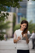 © Image Smith - Asian business woman using a digital tablet.
