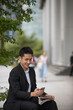 © Image Smith - Chinese business man using his mobile phone.
