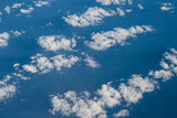 Fototapeta Na sufit - Aerial view of clouds and blue sky over ocean, cloudscape top view from airplane
