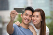 © Image Smith - Happy Asian couple taking a 'Selie' self portrait.