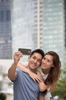 © Image Smith - Happy Asian couple taking a 'Selie' self portrait.