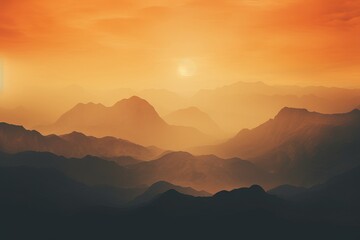 Wall Mural - misty mountains at sunset: high definition phone wallpaper with warm orange and yellow tones