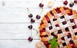 Cherry pie on a white wooden background with place for text. Tart with a cherry
