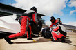 © Image Source - Pit crew in synchronized action during a highspeed race change