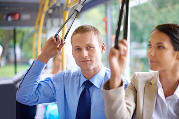 Canvas Print - Portrait, public transport and business man on bus for morning commute to work for start of career or job. Travel, work and young passenger riding metro with colleague in city for trip or transit