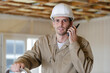 worker in safety vest using walkie talkie